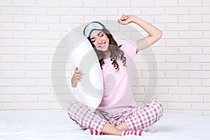 Girl with white pillow and sleeping mask