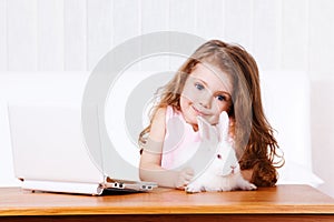 Girl with white rabbit and laptop