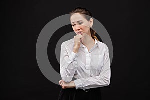 Girl in a white shirt is afflicted on a black background