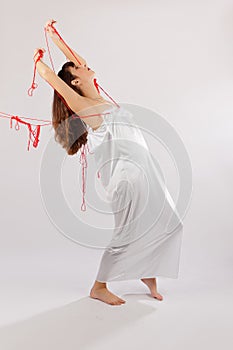 Girl white silk nightie pulled backwards red thread on white background
