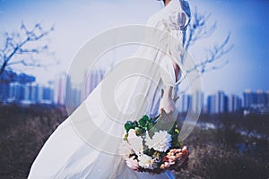 Girl in white skirt holding flowers