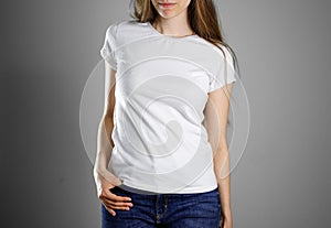Girl in white t-shirt and blue jeans. Ready for your design. Closeup. Isolated