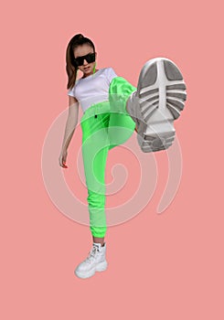 Girl in a white T-shirt and green sweatpants on a colored background