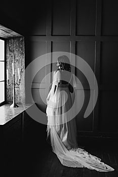 Girl in white wedding dress window