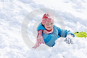 The girl who rolled down the hill has all her face in the snow, the girl looks funny into the frame