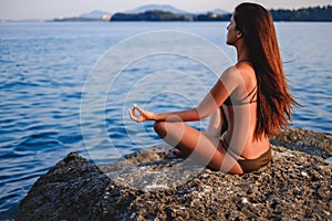 Girl with wind in hair relaxing in yoga pose