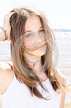 Girl wind on hairs in summer beach vacation