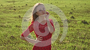 Girl wind nature. girl is standing in the field of green grass. Woman lifestyle freedom