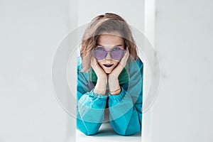 Girl in windcheater jacket and purple sunglasses