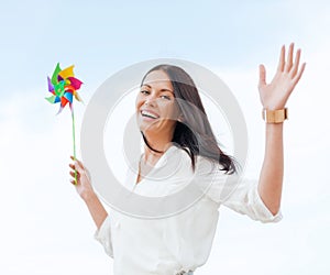 Girl with windmill toy on the beach