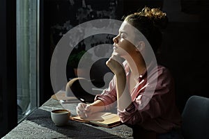 Girl by the window in a cafe