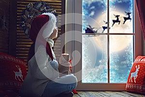 Girl by window at Christmas