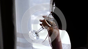 The girl at the window drinking champagne. Beautiful shots.