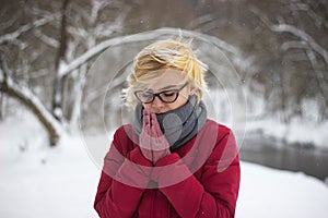 Girl in Winter Clothing warming her hads