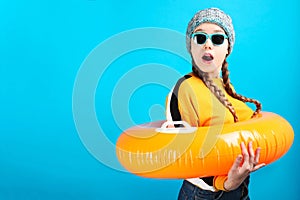 Girl in winter hat with orange nflatable circle