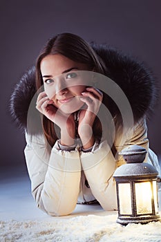 Girl on winter snow with lantern