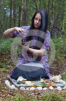 Girl witch conjures in the woods