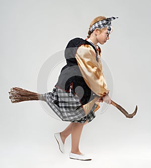 Girl in witch costume flying on a broomstick