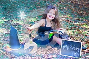 Girl in a witch costume for the Halloween holiday.