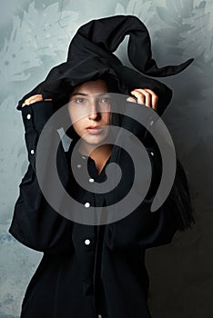 Girl in a witch costume looks mysteriously