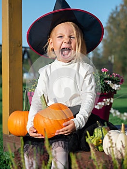 Girl in witch costume make scary faces