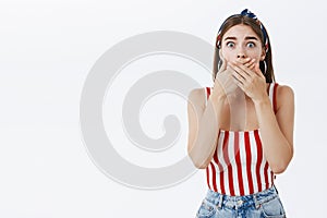 Girl witnesses horrible crime being stunned in shock covering mouth with both palms from fright and shook popping eyes