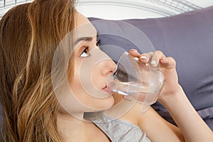 Girl woman drink water in bed at home, healthcare concept, hangover