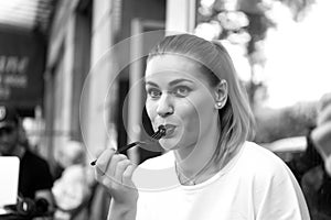 Girl or woman eat with fork in cafe in paris