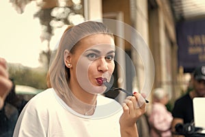 Girl or woman eat with fork in cafe in paris