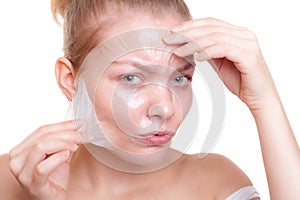 Girl woman in facial peel off mask. Skin care.