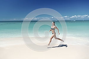 Girl or woman in sexy bikini run in antigua
