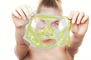 Girl woman showing facial peel off mask. Skin care