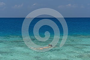 Girl woman snorkeling in summer tropical sandy beach turquoise water lagoon