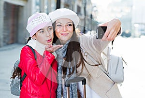 Girl and woman taking selfie on mobile phone