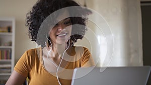 Girl woman teen with headphones learning online on laptop Spbd, asking teacher a question