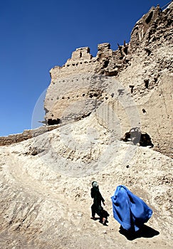 A girl and woman walk over the wall of the citadel in Ghazni, Afghanistan