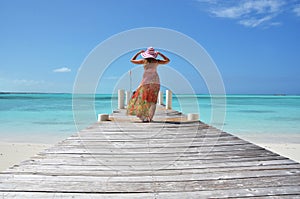 Girl on the wooden jetty. Exuma, Bahamas