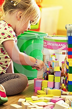 Girl with wooden toy blocks