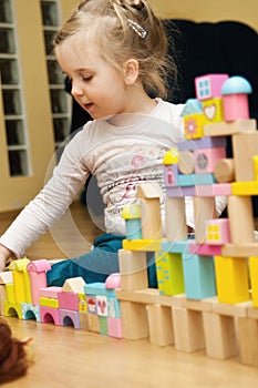 Girl with wooden toy blocks