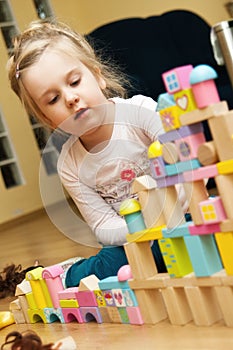 Girl with wooden toy blocks