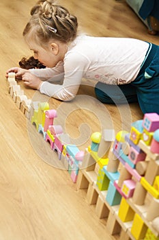 Girl with wooden toy blocks