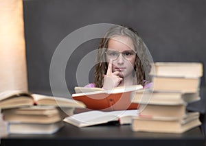 The girl wore glasses and reading a book