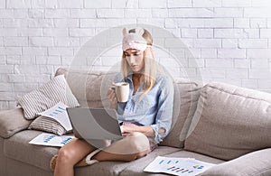 Girl work at home with laptop and charts