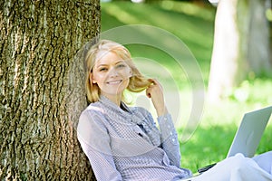 Girl work with laptop in park sit on grass. Education technology and internet concept. Natural environment office. Work