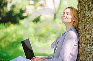 Girl work with laptop in park sit on grass. Natural environment office. Work outdoors benefits. Woman with laptop work