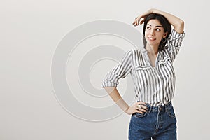 Girl on work looks in sky on airplane, dreaming to fly on vacation. Portrait of attractive stylish woman posing against