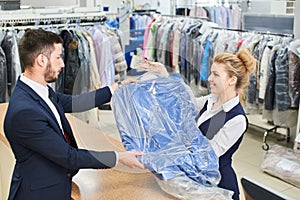 Girl worker Laundry man gives the client clean clothes