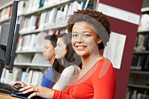 Girl working on computer in library