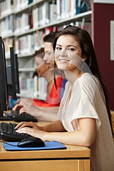 Girl working on computer in library