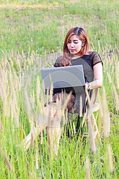 Girl working on her laptop computer outside